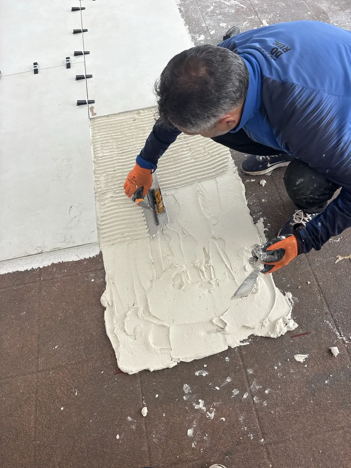 Tiling work being completed by hand